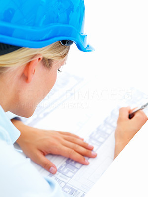 Closeup of an architect working on blue prints