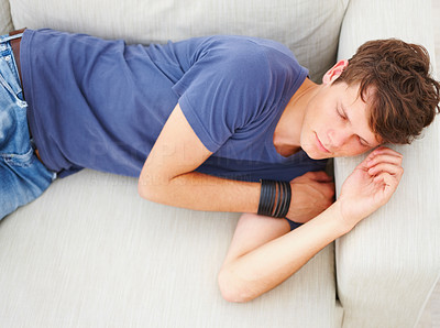 Young guy sleeping on sofa in home