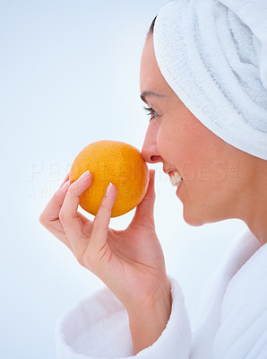 Closeup of a beautiful smiling girl drink orange juice isolated on white