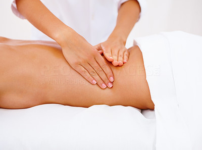 An attractive girl receiving back massage on white