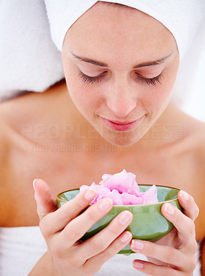 Detail portrait of a fresh young beautiful woman holding a flower isolated on white