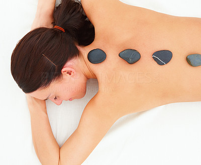 Lady receiving hotstone massage at spa