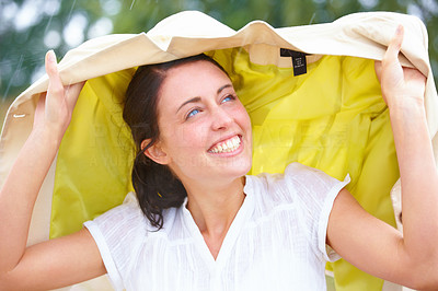 Portrait of a cheerful young lady enjoying rain