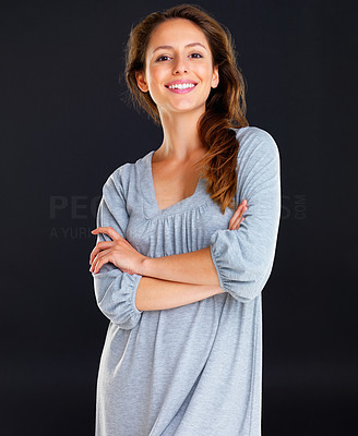 Happy woman standing with arms crossed