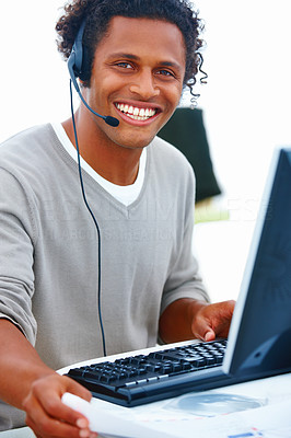 Closeup of a happy male executive with headset using headset