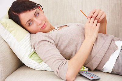 Young lady lying on sofa with nail file in hand