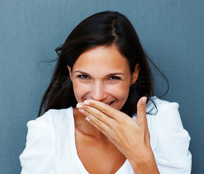 Shy woman with hand over mouth