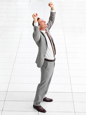 Young successful happy business man celebrating success in joy with arms wide open