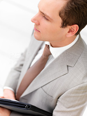 Successful handsome business man against white background, holding a folder