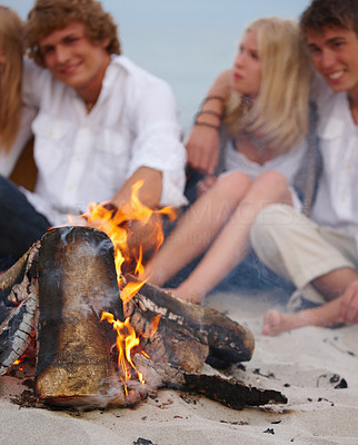 Friends by the fire on the beach