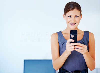 Smiling executive with mobile phone