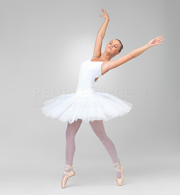 Cute ballerina dancing gracefully against white background