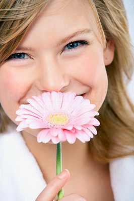 Young girl smelling flower
