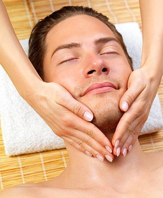 Portrait of happy man and hands giving face massage