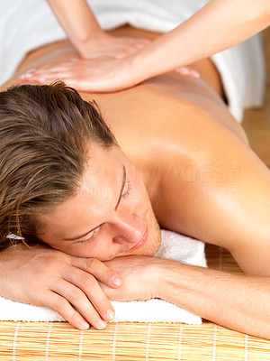 Happy man getting massage at spa