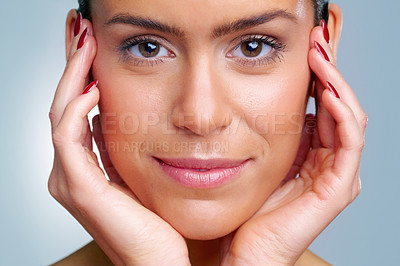 Macro view of a beautiful young woman with hands on chin