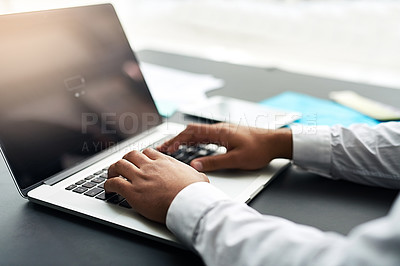 Buy stock photo Cropped shot of an unrecognizable businessman working on his laptop in the office