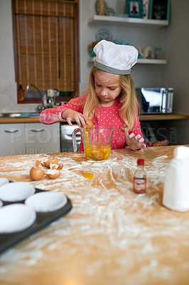 Buy stock photo Cropped shot of a little girl baking in the kitchen