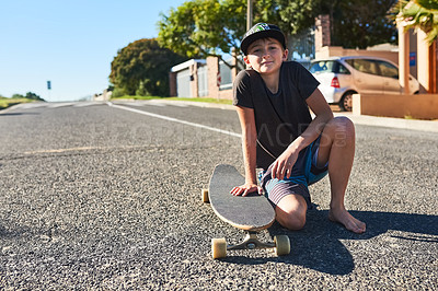 Buy stock photo Full length portrait of a young boy playing with his longboard in the street