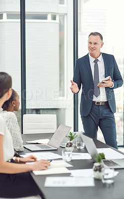 Buy stock photo Cropped shot of a businessman giving a presentation to his colleagues in a boardroom