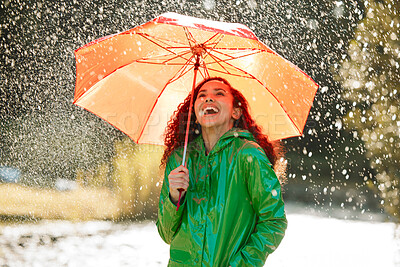 Buy stock photo Shot of a beautiful young woman having fun in the rain