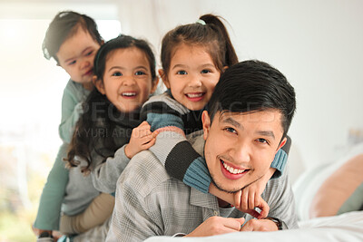 Buy stock photo Shot of a man bonding with his three kids at home
