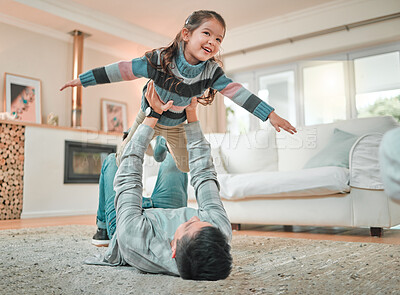 Buy stock photo Shot of a young father and daughter bonding while playing on the floor at home