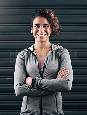 Buy stock photo Portrait of a young beautiful woman folding her arms against a black background