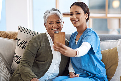 Buy stock photo Cropped shot of an attractive young female nurse taking selfies with a senior patient