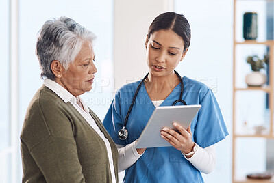 Buy stock photo Cropped shot of an attractive young female nurse showing a senior patient something on a laptop