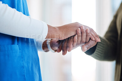 Buy stock photo Cropped shot of an unrecognizable nurse and a senior patient holding hands in comfort