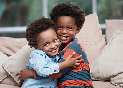 Buy stock photo Portrait of two little boys hugging each other at home