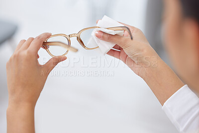 Buy stock photo Shot of a woman cleaning a pair of glasses