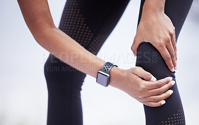 Buy stock photo Closeup shot of an unrecognisable woman experiencing knee pain while exercising outdoors