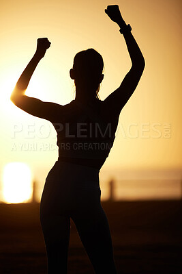 Buy stock photo Silhouetted shot of a woman cheering outdoors
