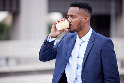 Buy stock photo Shot of a young businessman having coffee in the city