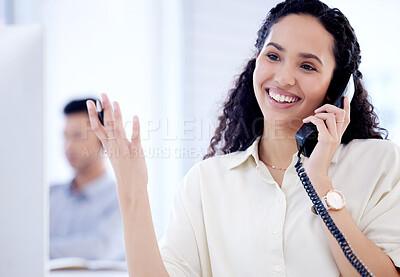 Buy stock photo Shot of a young businesswoman talking on a telephone while working in an office