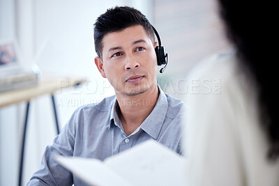 Buy stock photo Shot of a young call centre agent having a discussion with a colleague in an office