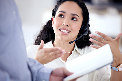Buy stock photo Shot of a young call centre agent talking to a colleague in an office