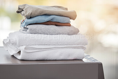 Buy stock photo Shot of folded laundry on a washing machine at home