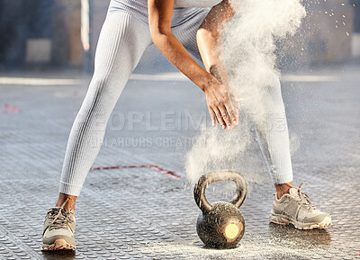 Buy stock photo Shot of an unrecognisable woman dusting her hands with chalk powder before working out with weights in a gym