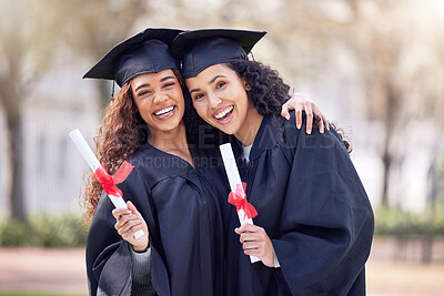 Buy stock photo Shot of two young women hugging on graduation day