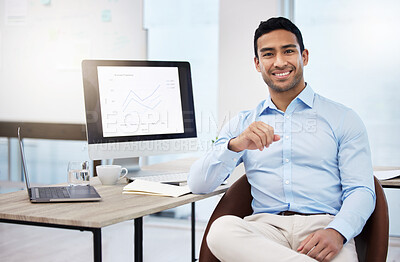 Buy stock photo Shot of a young businessman working at his desk