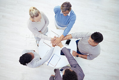 Buy stock photo Shot of a group of unrecognizable businesspeople stacking their hands in a modern office
