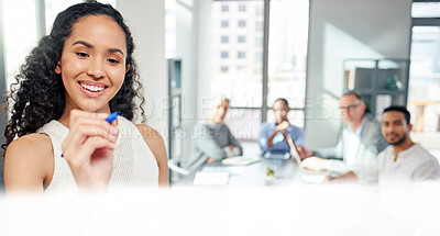 Buy stock photo Shot of a young businesswoman writing notes while giving a presentation to her colleagues in an office