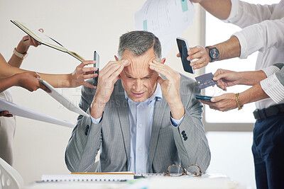 Buy stock photo Shot of a stressed older businessman being bothered by staff