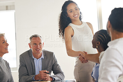 Buy stock photo Shot of a young businesswoman welcoming a new team member aboard