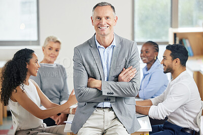 Buy stock photo Shot of a senior businessman during a staff meeting