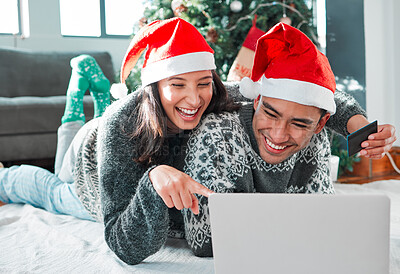 Buy stock photo Shot of a young couple using a laptop and credit card at home