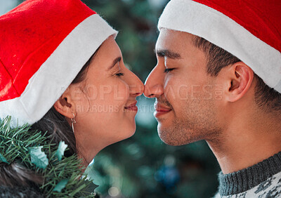 Buy stock photo Shot of a young couple celebrating Christmas together at home